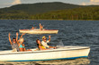 Group of friends racing with motorboats