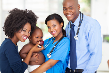 Wall Mural - african pediatricians with mother and baby after checkup