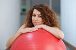 © pio3 - Young woman with red ball portrait in the gym.