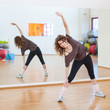 © pio3 - Young woman stretching her leg in the gym.