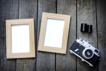 Old empty photos frame with retro camera background concept