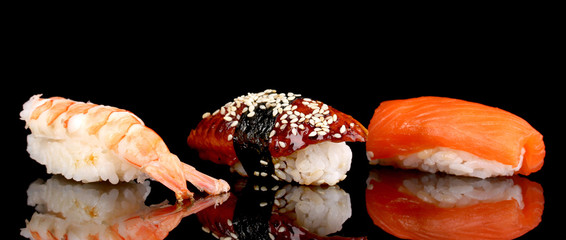 Wall Mural - delicious sushi isolated on black