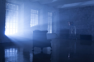 a seat in blue backlight in studio with three windows