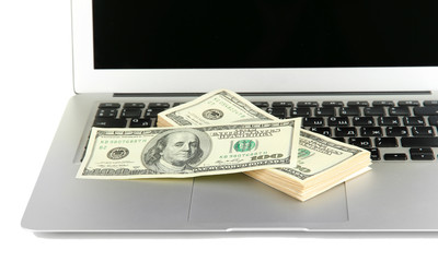 Money on laptop isolated on white