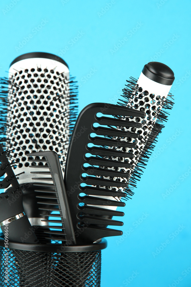 Iron basket with combs and round hair brushes,