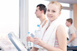 © mr.markin - Man and woman drinking water after sports in gym
