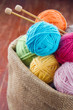 Woolen balls of yarn in a rustic craft bag