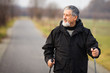© lightpoet - Senior man nordic walking, enjoying the outdoors