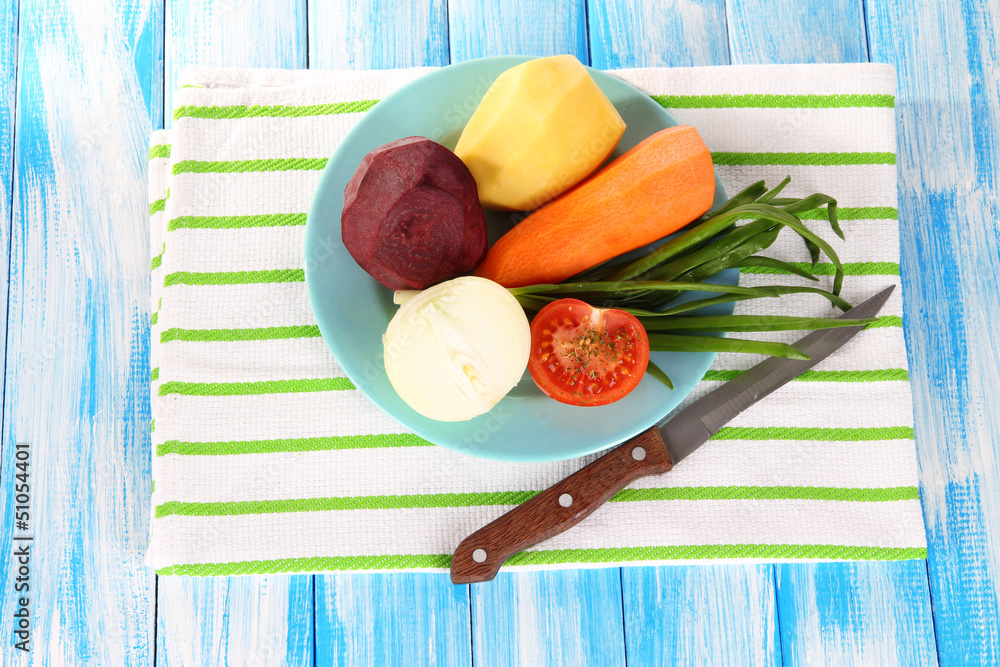 Peeled vegetables on plate on napkin