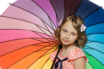 Closeup of little girl standing under colorful umbrella