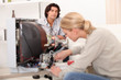 © auremar - Woman repairing a television set