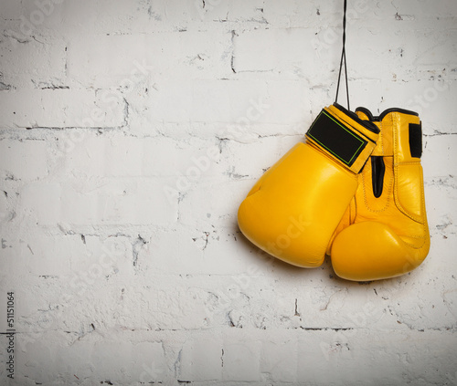 Naklejka ścienna Pair of boxing gloves hanging on a wall