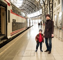 Happy Mother With Her Son On Train Station Platform