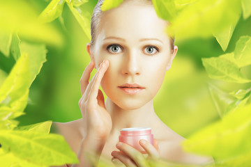 Wall Mural - beauty woman with cream and  natural skin care in green