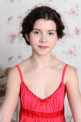 Portrait of pretty little girl in red dress