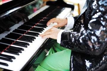 hands of a man playing piano