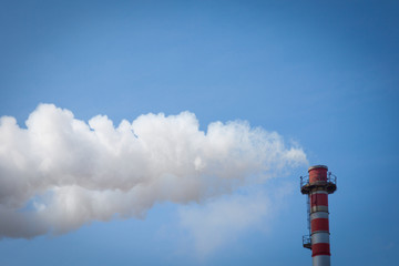 Chimney smoke with blue sky