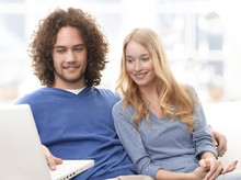Happy Young Couple Shopping On The Internet