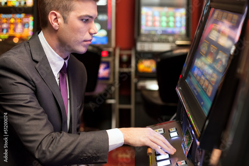 фотография Men gambling in the casino on slot machines