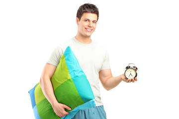 Sticker - A smiling man in pajamas holding a pillow and alarm clock