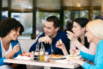 Cheerful friends chatting while lunch