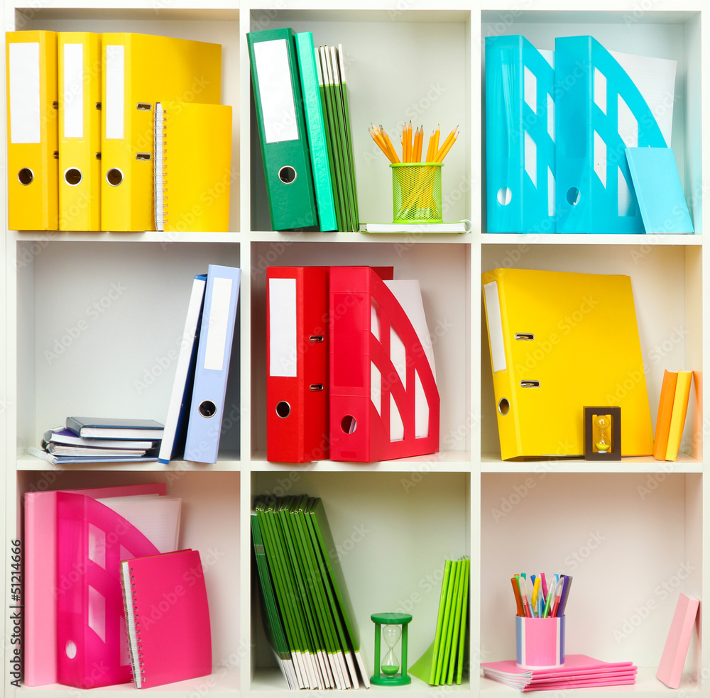 White office shelves with different stationery, close up