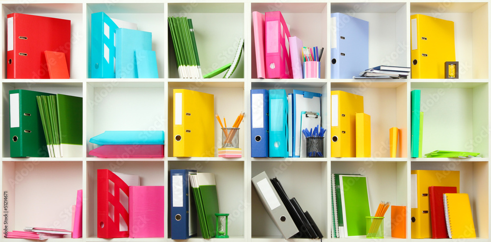 White office shelves with different stationery, close up