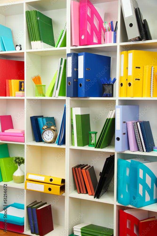 White office shelves with different stationery, close up