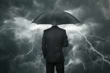 Businessman With Umbrella Standing In The Rain