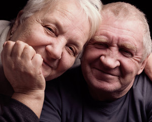 happy older pair on a black background