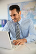© goodluz - Smiling businessman working in office