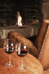 Wall Mural - Two Glasses Of Red Wine At A Cosy Fireplace