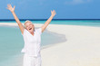 © Monkey Business - Senior Woman With Arms Outstretched On Beautiful Beach