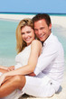 © Monkey Business - Romantic Couple Sitting On Beautiful Tropical Beach
