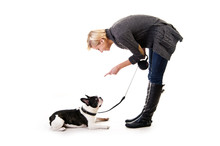 Woman With Her Dog On Leash Over White Background