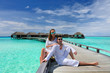 © haveseen - Couple on a beach jetty at Maldives