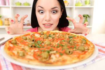 Beautiful girl wants to eat delicious pizza