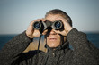 © RistoH - Man looking with binoculars