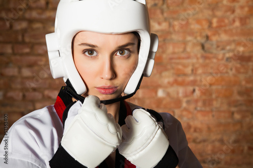 Leinwand Poster Woman in sportswear and brick wall
