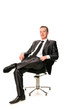 © len44ik - Confident smiling young businessman sitting on a chair