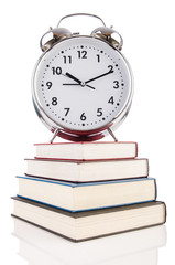 Wall Mural - Alarm clock and books isolated on white