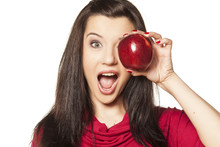 Dark-haired Girl With Blue Eyes Showing Red Apple