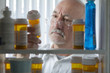 Man reaching for prescription form medicine cabinet
