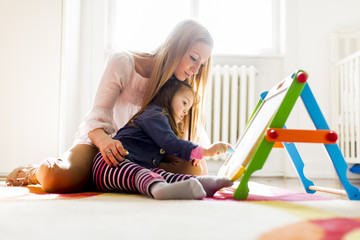 Canvas Print - Mother and daughter drawing in the room