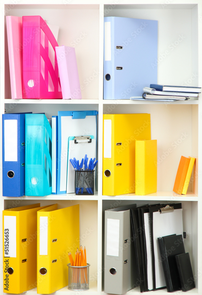White office shelves with different stationery, close up