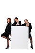 © auremar - Three businesswomen with blank poster