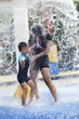 © Creativa Images - Family having fun in water park