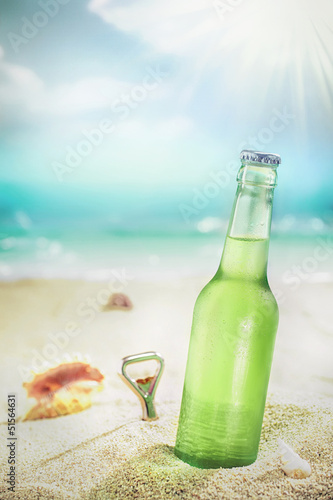 Naklejka na szybę Ice cold bottle of lager or soda on a beach