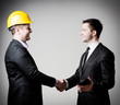 © slasnyi - business man handshake with construction