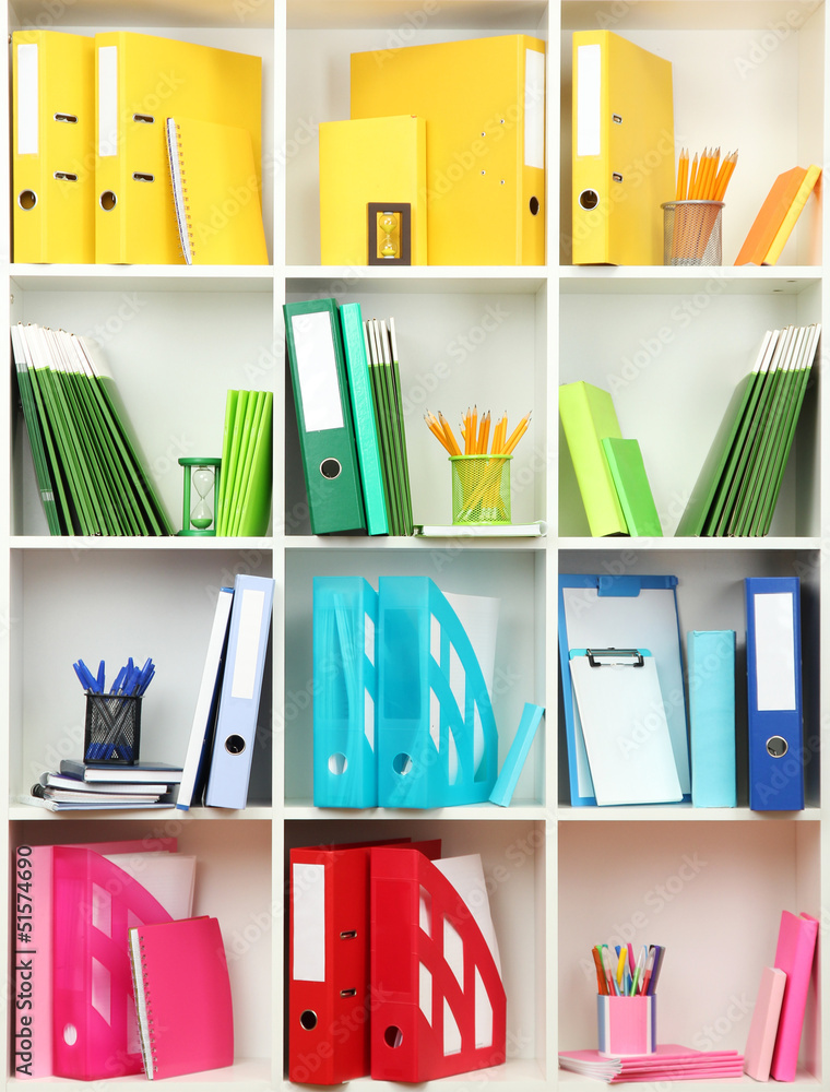 White office shelves with different stationery, close up